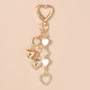 Gold-toned pearl bow heart keychain with multiple heart charms for bags and keys