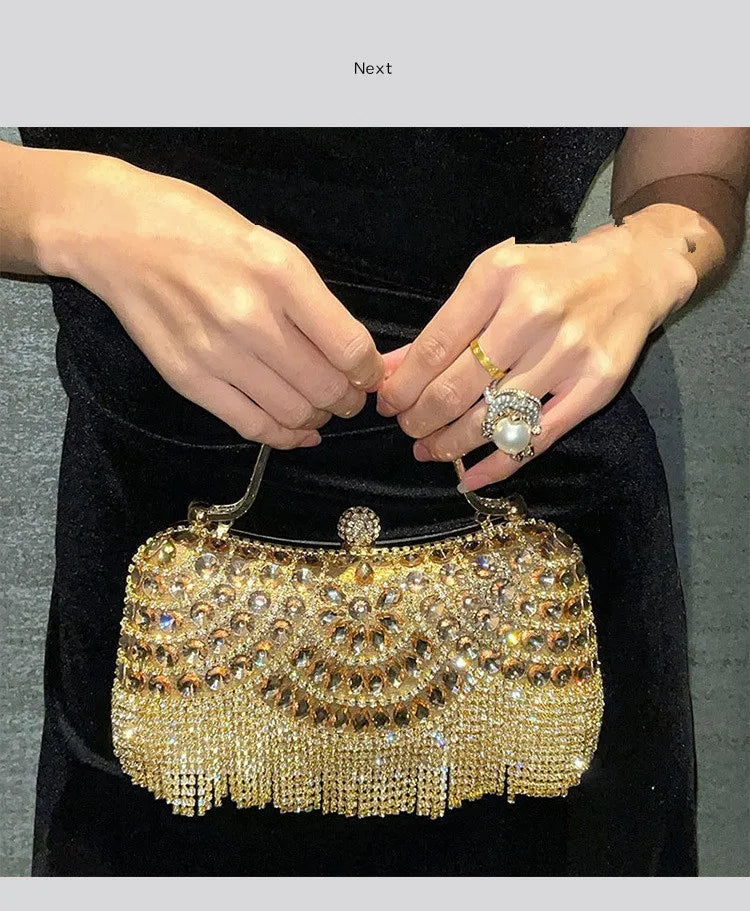 A close-up of a golden diamond rhinestone evening clutch bag with a tassel being held by a person.