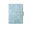 Light blue leather passport organizer with a stitched flap and the word PASSPORT embossed on it.