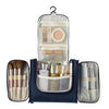A navy blue multi-compartment travel pouch with floral print accents and various cosmetic tools inside.
