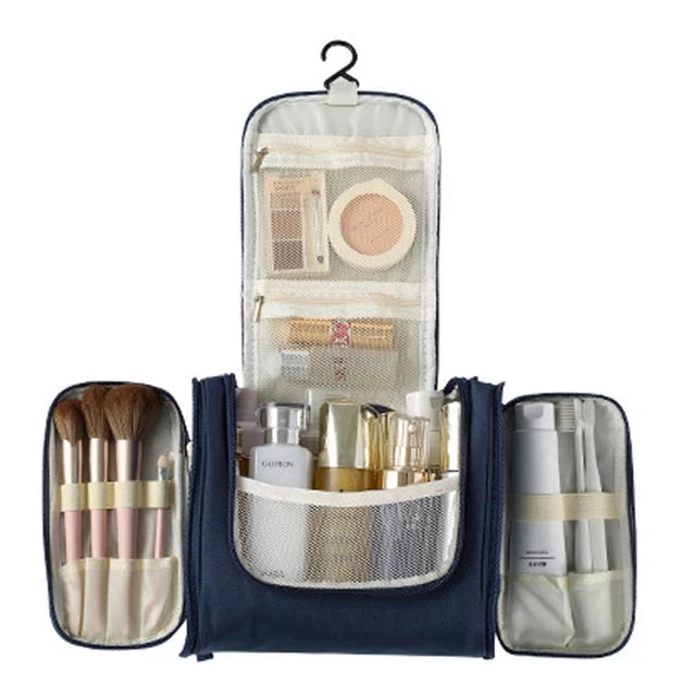 A navy blue multi-compartment travel pouch with floral print accents and various cosmetic tools inside.