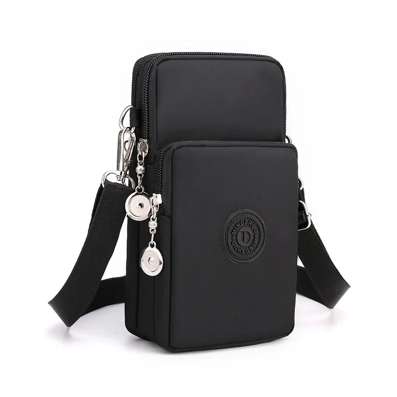 Black compact nylon crossbody phone bag with a silver chain and adjustable strap.