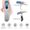 A portable digital luggage scale shown in a sleek silver finish, displaying weight measurements and featuring hook or webbing
