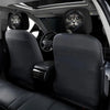 Two black car headrest covers with cute cat faces are shown in a vehicle interior.