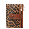 A brown leopard print card holder wallet with a leather flap and gold-toned zipper.