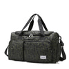 A dark green leopard print travel duffel bag with a separate shoe compartment.