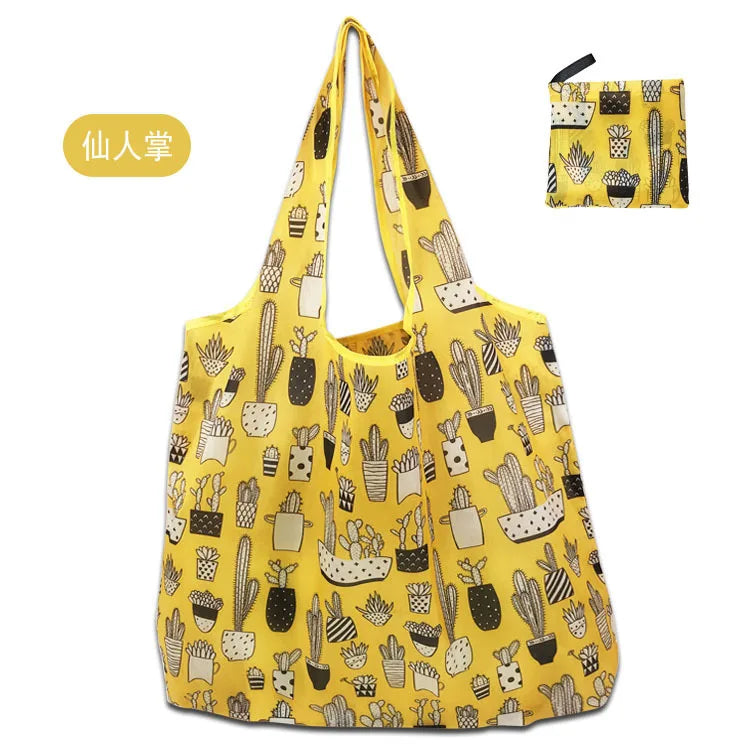 A yellow reusable shopping bag patterned with various cacti and succulents.