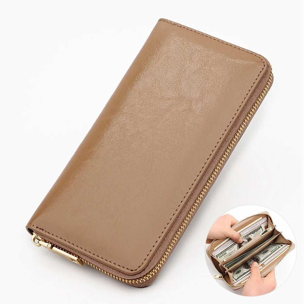 A tan genuine leather zipper wallet is shown open, displaying folded currency inside.