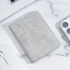 A gray ultra-thin multi-slot card wallet resting on a white marble surface.