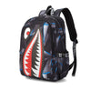 A black casual travel backpack featuring a stylized red and white shark tooth design.