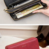 A close-up of a red leather wallet with a gold zipper and multiple card slots is shown being held by a hand.
