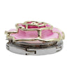 A gold-toned heart-shaped metal foldable bag hook with a pink enamel detail and silver metal base.