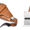 A brown men's PU leather crossbody sling bag is shown next to a white iPad, demonstrating its size and style.