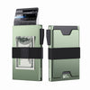 A light green minimalist metal card holder with an expandable black backplate and a stack of credit cards.