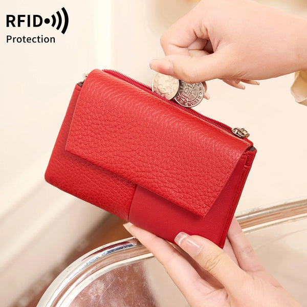 A red tri-fold RFID blocking wallet with a zipper closure is being held by a hand, showing its protection feature.
