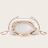 Elegant gold-tone evening clutch bag with a curved metallic gold accent on a light, iridescent white bag.