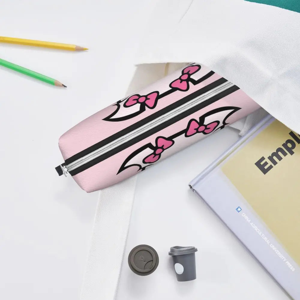 Pink leather pencil case with black stripes and pink bows resting on a white surface.