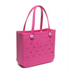 A bright pink portable EVA beach tote bag with handles and small holes.