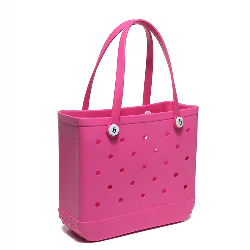 A bright pink portable EVA beach tote bag with handles and small holes.