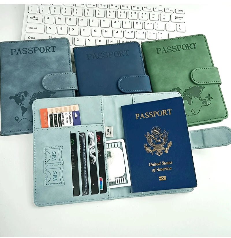 A set of elegant RFID blocking passport holders in various shades of blue, green, and gray are displayed next to a laptop key