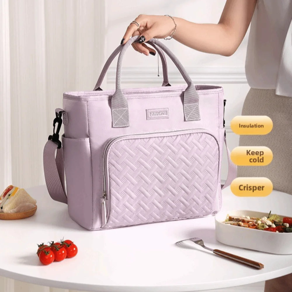 A light purple insulated lunch bag with a quilted pattern is shown on a white table next to fresh food.