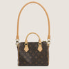 A brown synthetic leather handbag with a gold-toned adjustable strap and gold hardware.