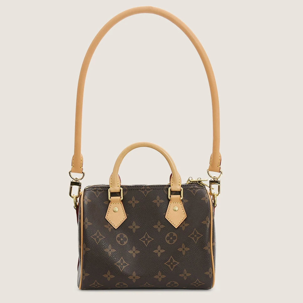 A brown synthetic leather handbag with a gold-toned adjustable strap and gold hardware.