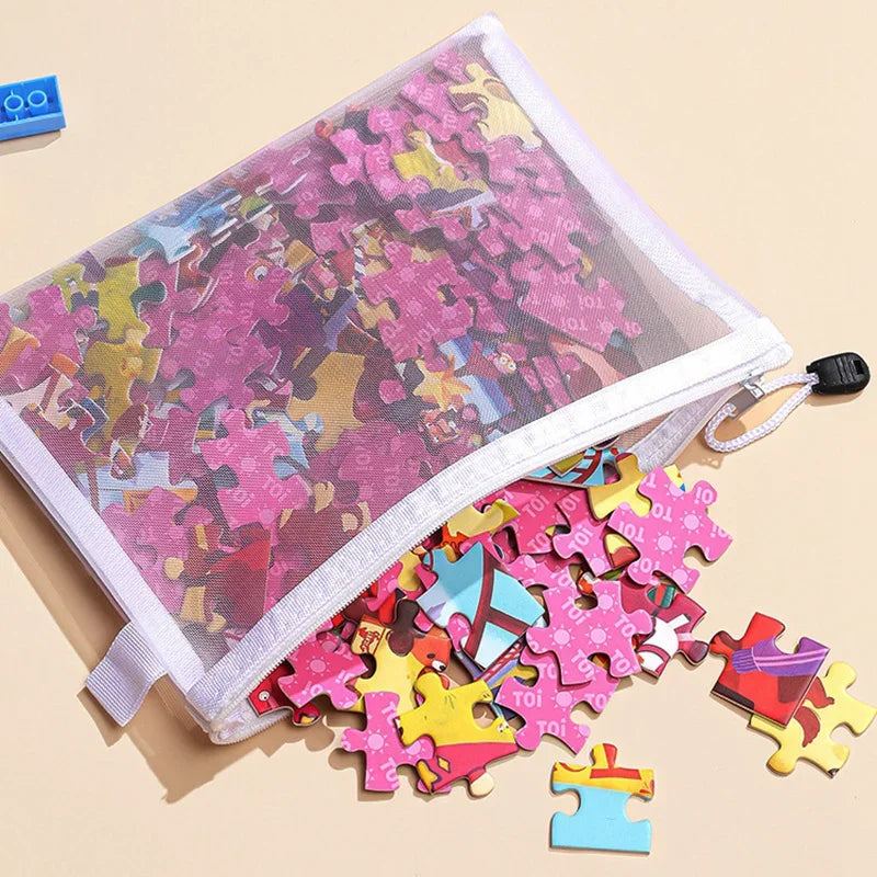 A clear mesh zipper pouch filled with colorful puzzle pieces and small plastic blocks.