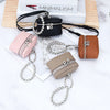 A collection of handcrafted leather coin purses and neck pendants in pink, brown, and beige with silver chains and black lany