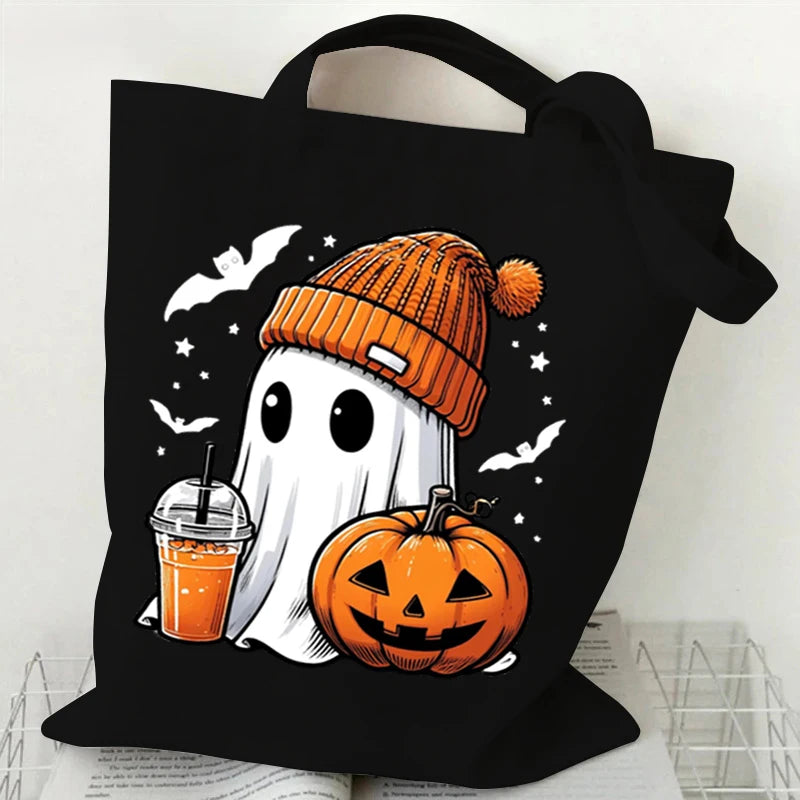 Black canvas tote bag featuring a white ghost and orange pumpkin print for Halloween