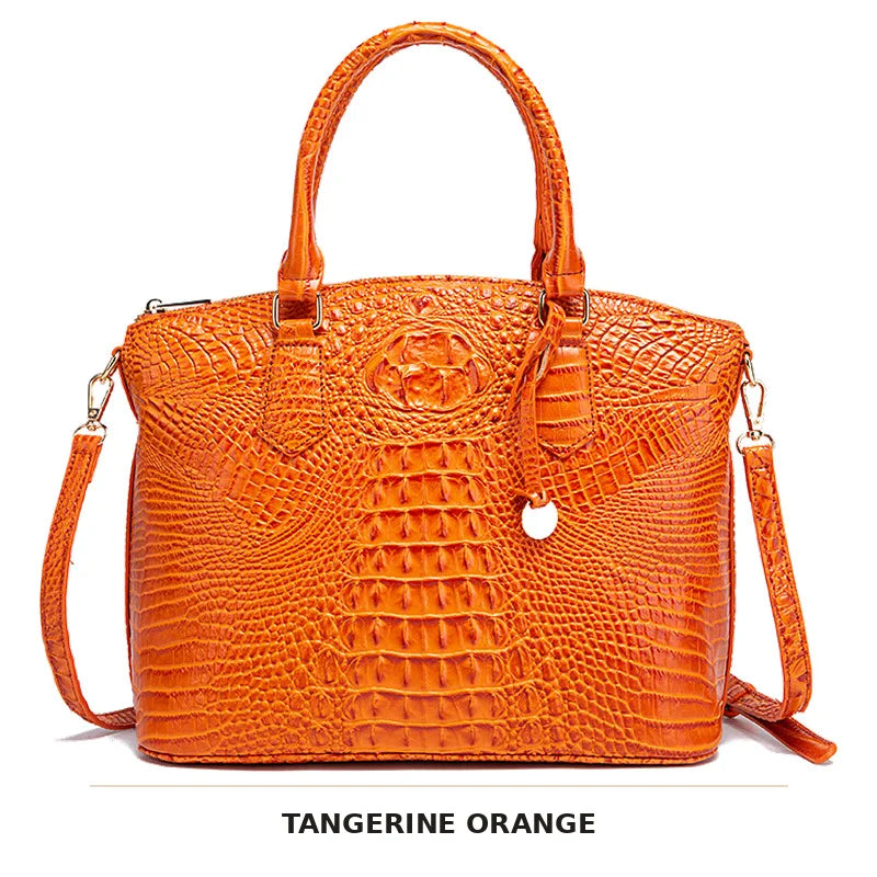 Orange Krokodilmuster-Oberteil mit Henkel und Crossbody-Tasche.