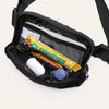 Black nylon cross-body waist bag containing a phone, credit card, and various small items.