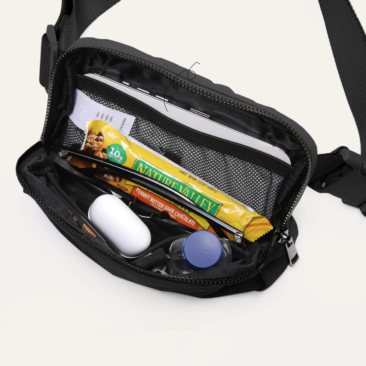 Black nylon cross-body waist bag containing a phone, credit card, and various small items.