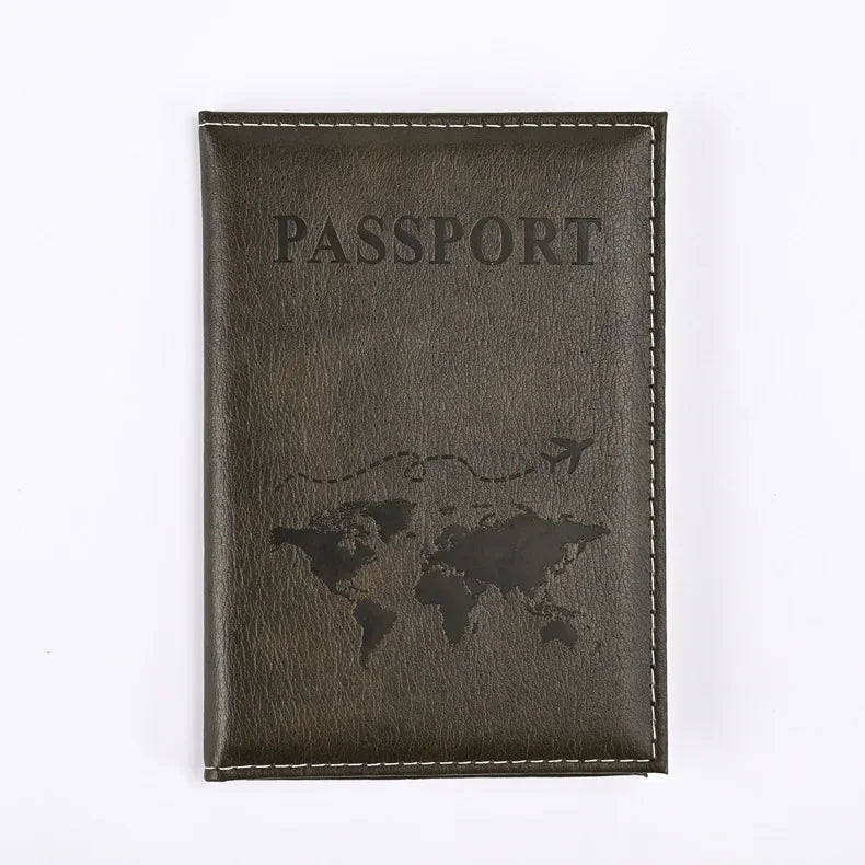A dark brown leather passport holder with the word PASSPORT embossed and a silhouette of the world map.