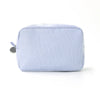 A light blue and white striped seersucker cosmetic bag with a zipper closure.
