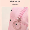 Close-up of a pink fabric pouch with a metal buckle closure and a smooth zipper detail.