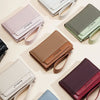 A collection of women's zip-around wallets in various colors including pink, olive green, brown, and burgundy.