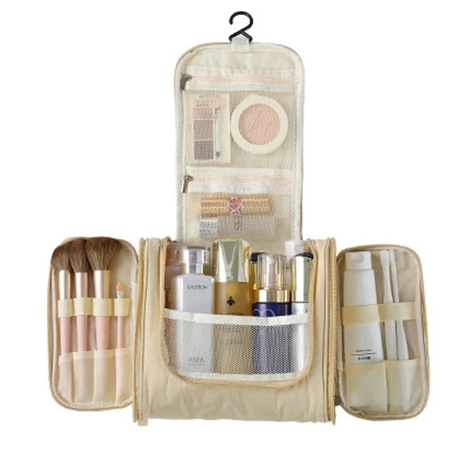 A beige multi-compartment travel pouch containing various makeup brushes and cosmetic items.