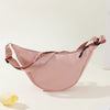 A light pink women's preppy sling crossbody bag is shown against a white background.