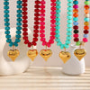 A necklace featuring colorful heart-shaped beads in shades of blue, red, and pink resin.