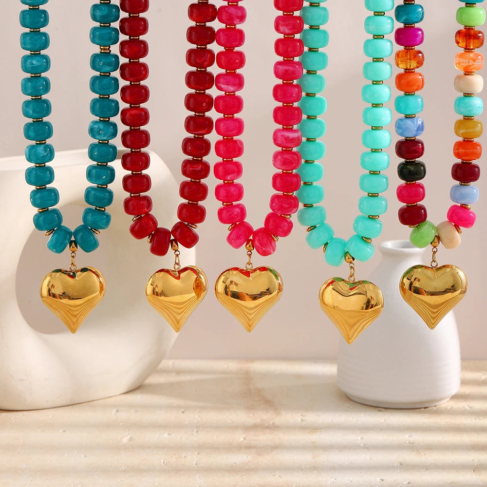 A necklace featuring colorful heart-shaped beads in shades of blue, red, and pink resin.