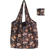 A black tote bag with a floral print featuring swirling brown and beige patterns.