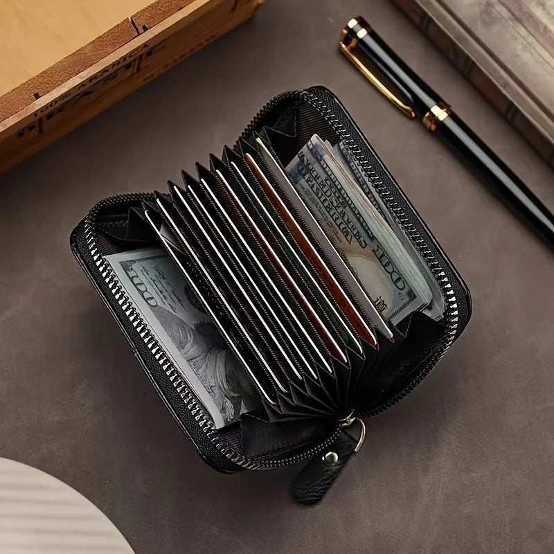A black slim wallet with a zipper is open, displaying several folded US dollar bills and a pen on a dark gray surface.