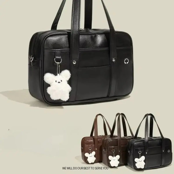Black waterproof PU leather student messenger bag with a white bear charm