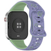 Reloj inteligente con caja verde claro y correa de silicona floral morada.