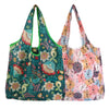 A pair of reusable fashion shopping tote bags featuring floral and abstract patterns in shades of green, pink, and yellow.