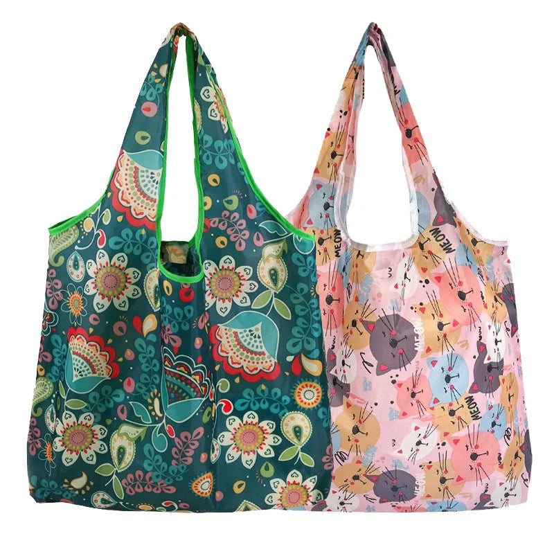 A pair of reusable fashion shopping tote bags featuring floral and abstract patterns in shades of green, pink, and yellow.