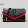 Black alligator pattern leather clutch bag with red accent and gold chain detail