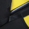 Black stretch fabric luggage protector cover with a black strap and yellow background.