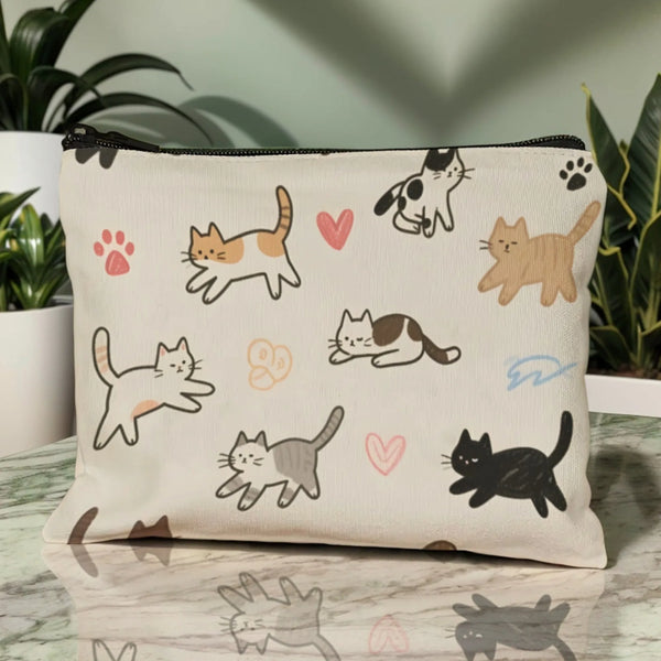 A cream-colored pouch featuring various cartoon cats in black, orange, and gray outlines.
